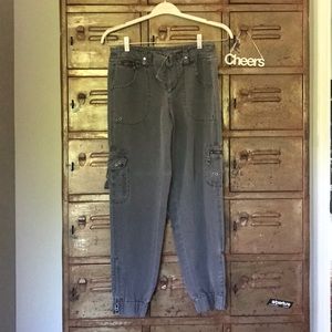 Grey loose fitting pants with zippers and pockets